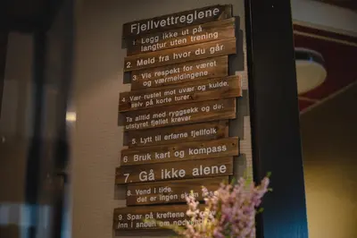 a menu on a wall with flowers on it at Trolltun Hotel & Hytter in Dombås