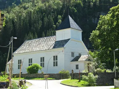 a white church with a black roof at Rongahuset BnB in Evanger