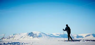 a man on skis in the snow with mountains in the background at Storefjell Resort in Gol