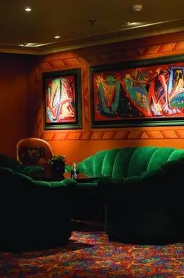 a room with a green couch and paintings on the wall at Storefjell Resort in Gol