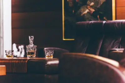 two glasses of whiskey on a table in a bar at Tyssedal Hotel in Tysso
