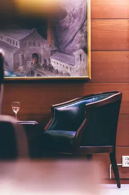 a dining room with a table and a painting on the wall at Tyssedal Hotel in Tysso