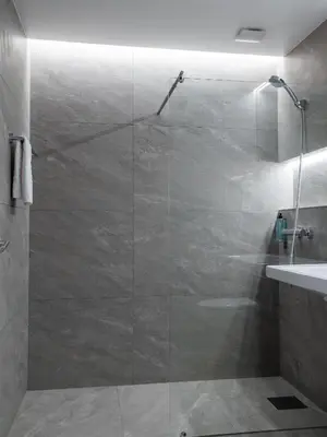 a shower with a glass door in a bathroom at Tyssedal Hotel in Tysso