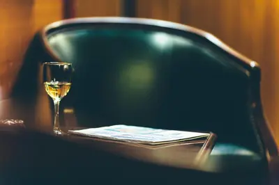 a glass of wine sitting on top of a table at Tyssedal Hotel in Tysso