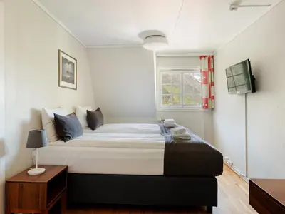 a bedroom with a large bed and a window at Tyssedal Hotel in Tysso