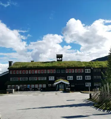 a building with a grass roof on top of it at Gudbrandsgard Hotel in Kvitfjell