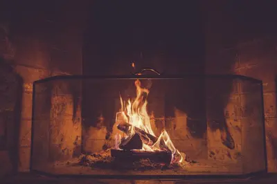 a fireplace with a fire in it at Gudbrandsgard Hotel in Kvitfjell