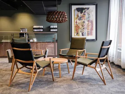 a group of chairs and a table in a room at Quality Hotel Grand Kristiansund in Kristiansund