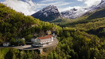 an aerial view of a house in the mountains at Hotel Utsikten - by Classic Norway Hotels in Geiranger
