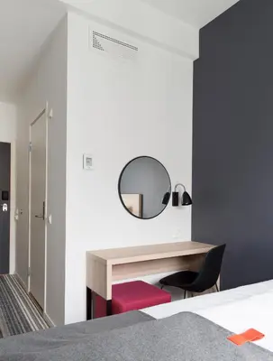 a bedroom with a desk and a mirror at Citybox Bergen City in Bergen
