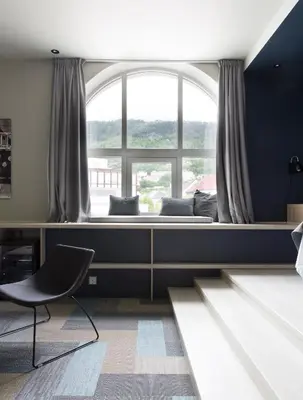 a bedroom with a bed and a large window at Citybox Bergen City in Bergen