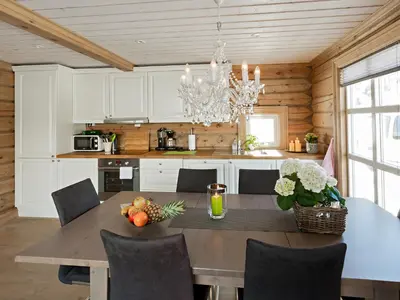 a kitchen with a dining room table and a dining room at Stranda Fjellgrend in Stranda