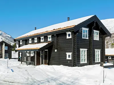 a log cabin in the snow with snow at Stranda Fjellgrend in Stranda