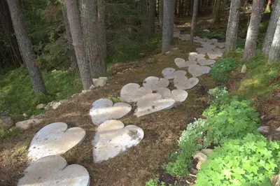 a group of stone hearts on the ground in a forest at Elvebakk Bed & Breakfast in Reed