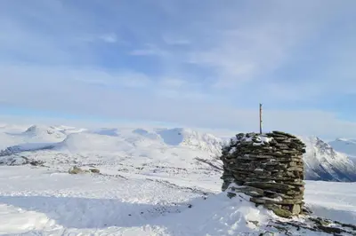 a stone tower on top of a snow covered mountain at Elvebakk Bed & Breakfast in Reed
