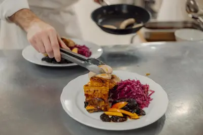 a person cutting a plate of food on a counter at Best Western Tingvold Park Hotel in Steinkjer