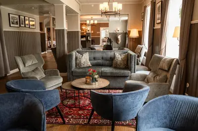 a living room with couches and chairs and a table at Gloppen Hotell - by Classic Norway Hotels in Sandane