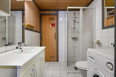 a bathroom with a sink and a toilet and a shower at Solbjørnlia Apartments in Trysil