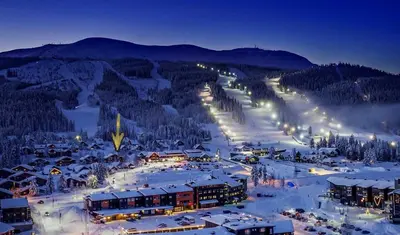 a ski resort in the snow at night at Solbjørnlia Apartments in Trysil