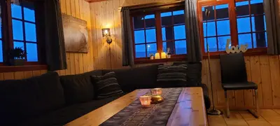 a living room with a couch and a wooden table at Solbjørnlia Apartments in Trysil