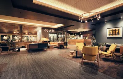 a lobby of a hotel with chairs and tables at Bergstadens Hotel & Spa in Røros