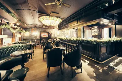 a restaurant with chairs and tables and a bar at Bergstadens Hotel & Spa in Røros