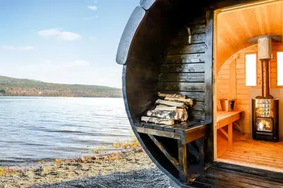 a boat sitting on the shore of a body of water at Hurdalsjøen Hotel & Spa in Hurdal