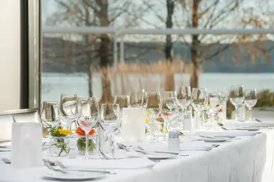 a table with wine glasses and plates on it at Hurdalsjøen Hotel & Spa in Hurdal