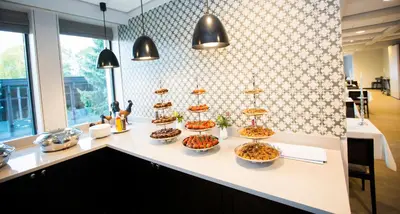 a bunch of bowls of food on a counter at Hurdalsjøen Hotel & Spa in Hurdal