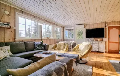 a living room with a couch and a table at Amazing Home In Sjusjøen With Wifi in Sjusjøen