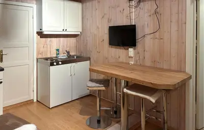 a kitchen with a wooden table and a sink at Nordseter Sportell 271 in Lillehammer