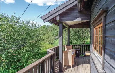 a porch of a house with a wooden deck at Amazing Home In Vågå With Kitchen in Vaga