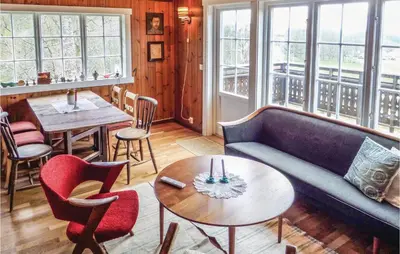 a living room with a couch and a table and chairs at Stunning Home In Førde I Hordaland in Førde