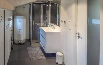 a bathroom with a sink and a shower and a toilet at Stunning Home In Førde I Hordaland in Førde