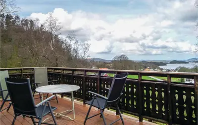 a table and chairs on a balcony with a view at Stunning Home In Førde I Hordaland in Førde