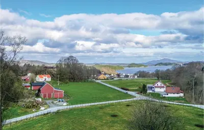 a small town with a green field and a lake at Stunning Home In Førde I Hordaland in Førde