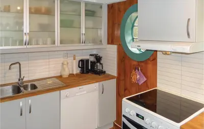 a kitchen with white cabinets and a sink at Stunning Home In Førde I Hordaland in Førde