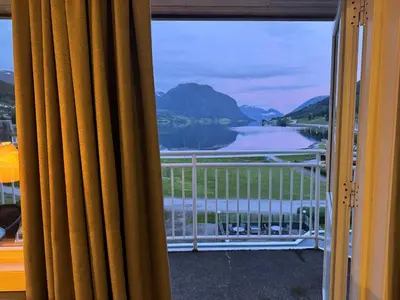 a view of a lake from a window at Grand Hotel Skei - Unike Hoteller in Skei
