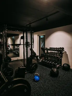 a room with a bunch of weights in a gym at Hotel Noreg in Ålesund