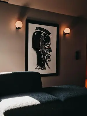 a bedroom with a picture of a helmet on the wall at Hotel Noreg in Ålesund
