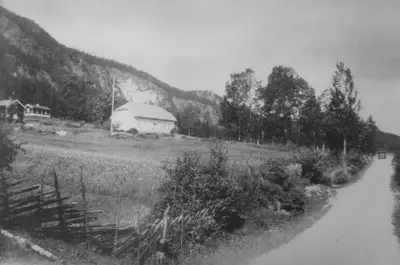 a black and white photo of a farm with a barn at Smedsgården Hotel in Nesbyen