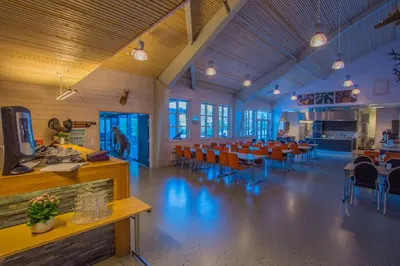 a dining room with tables and chairs in a building at Thon Hotel Bjørneparken in Flå