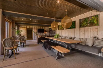 a living room with a couch and a table and chairs at Lillehammer Turistsenter Budget Hotel in Lillehammer