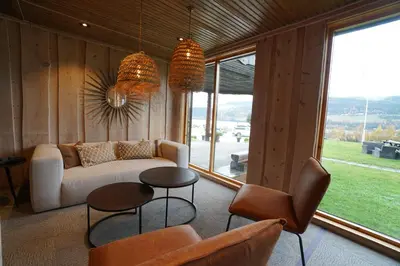a living room with a couch and a table and chairs at Lillehammer Turistsenter Budget Hotel in Lillehammer