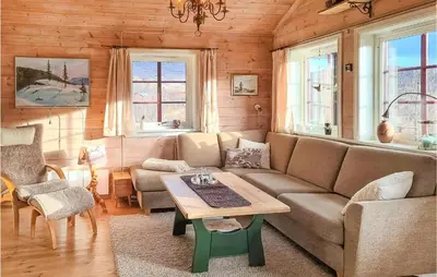 a living room with a couch and a table at Beautiful Home In Vøringsfoss With Wifi in Maurset
