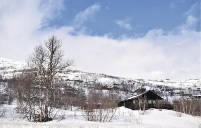 a cabin in the snow on a snowy mountain at Beautiful Home In Vøringsfoss With Wifi in Maurset