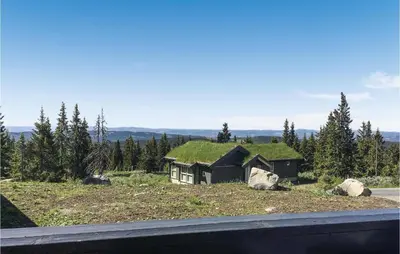 a house with a grass roof on a hill at Nice Home In Lillehammer With Sauna in Lillehammer