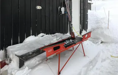 a snow machine sitting in front of a building at Nice Home In Lillehammer With Sauna in Lillehammer