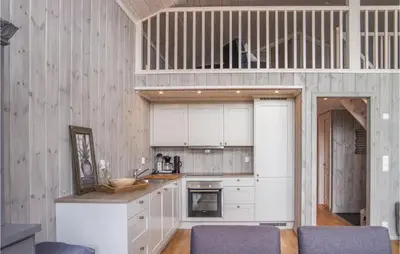 a kitchen with white cabinets and a counter top at Nice Home In Lillehammer With Sauna in Lillehammer