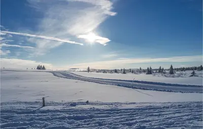 a snow covered field with the sun in the sky at Sjusjøen Setergrend 4724 B in Sjusjøen
